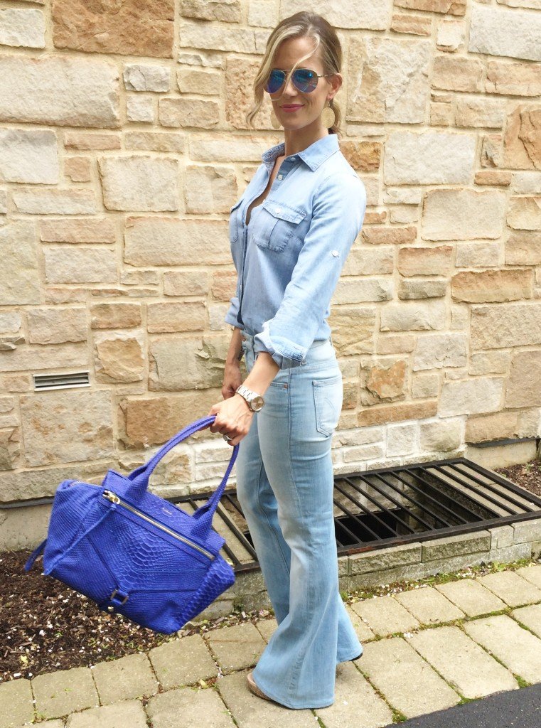 Denim on denim, wedges, and blue handbag