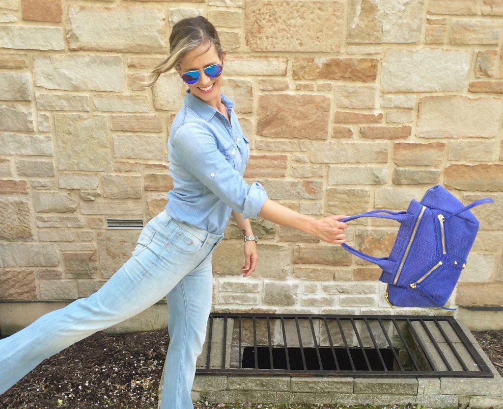 Denim on denim, wedges, and blue handbag