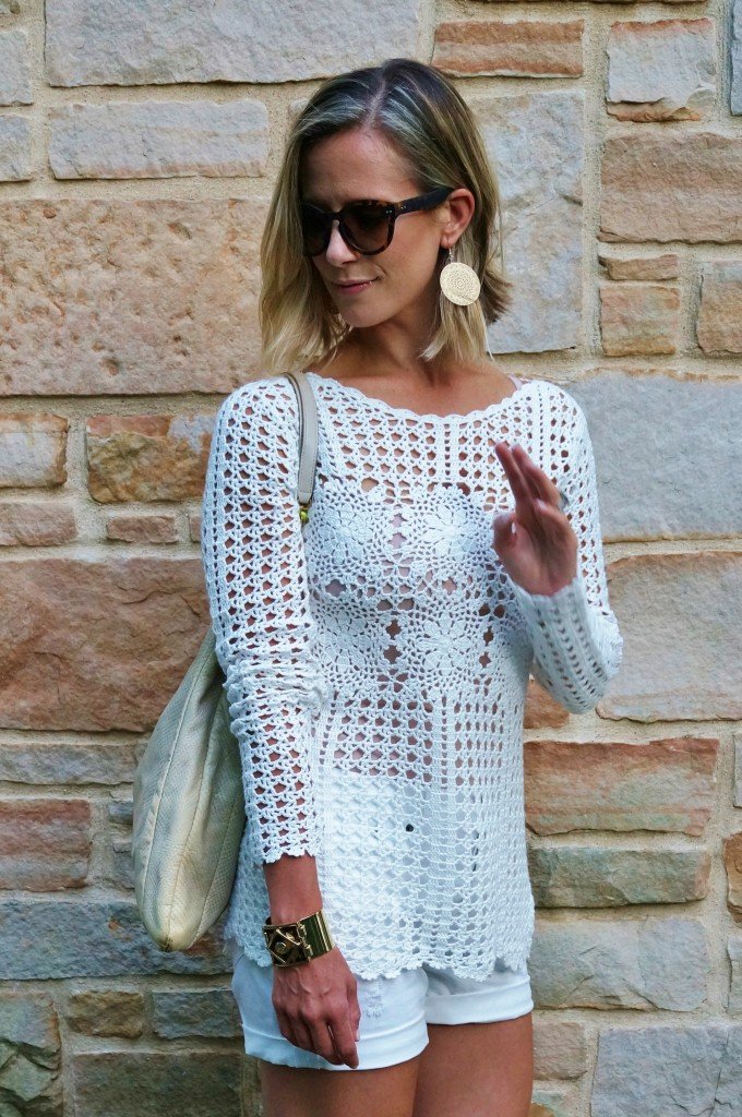 Neutral sweater, white shorts, tote, wedges, and sunglasses