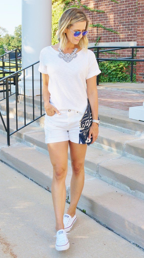 White outfit: white tee, white denim, clutch, Converse