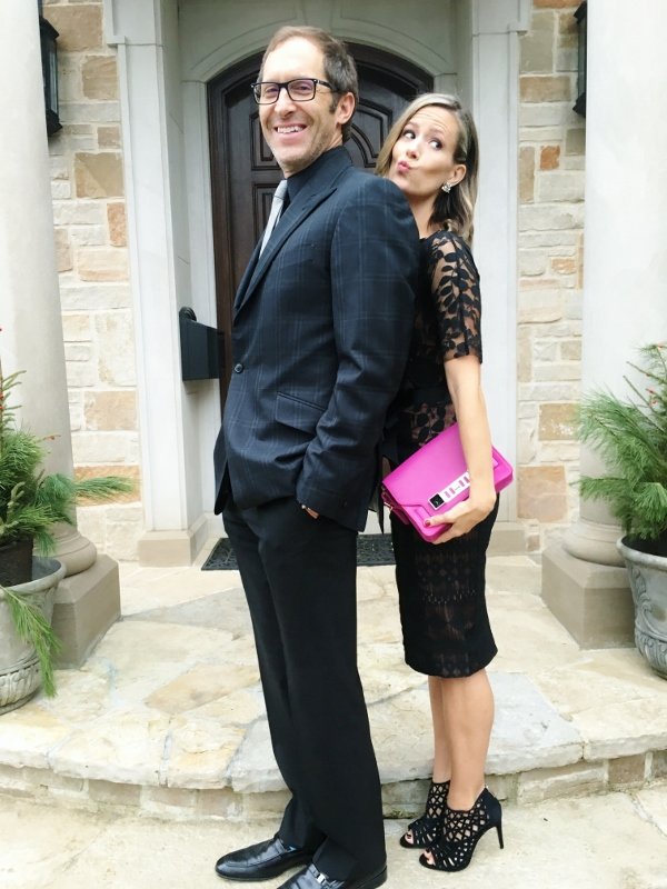 Date night outfit: black dress, heels, and pink clutch