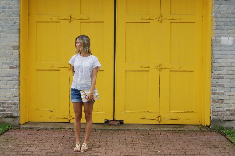 Eyelet top, denim shorts, sandals, clutch