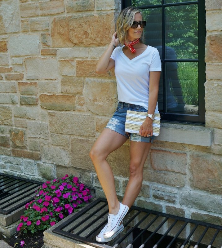 Summer style: white tee, denim shorts, red bandana, straw clutch, sunglasses, and Converse