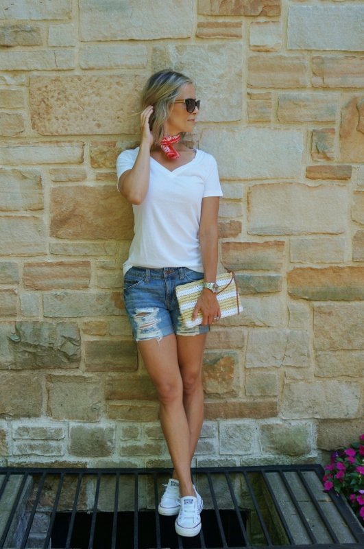 Summer style: white tee, denim shorts, red bandana, straw clutch, sunglasses, and Converse