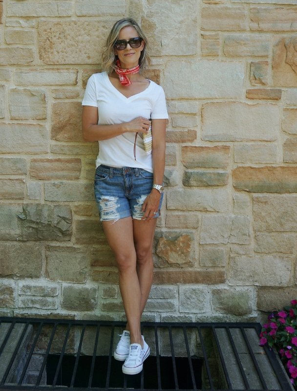 Summer style: white tee, denim shorts, red bandana, straw clutch, sunglasses, and Converse