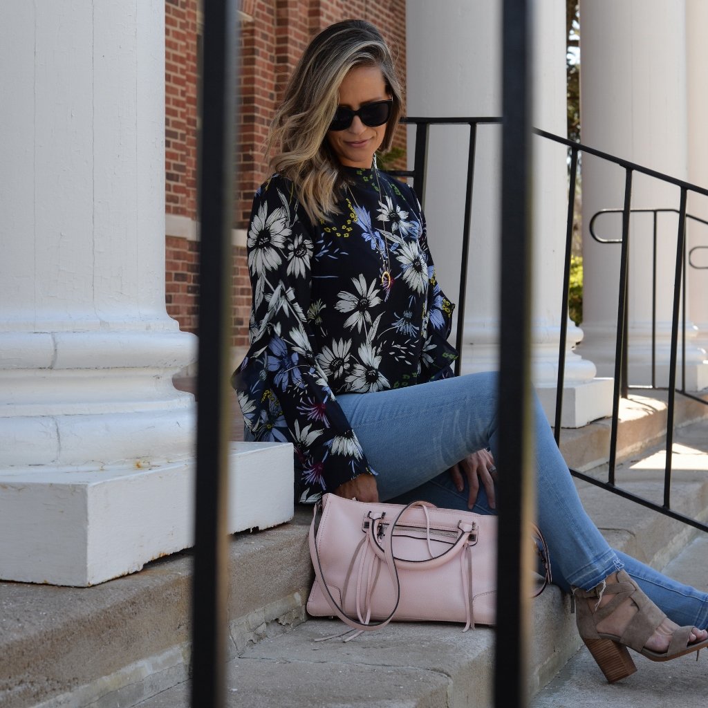 Floral top, denim, sunglasses, pink purse, and heels