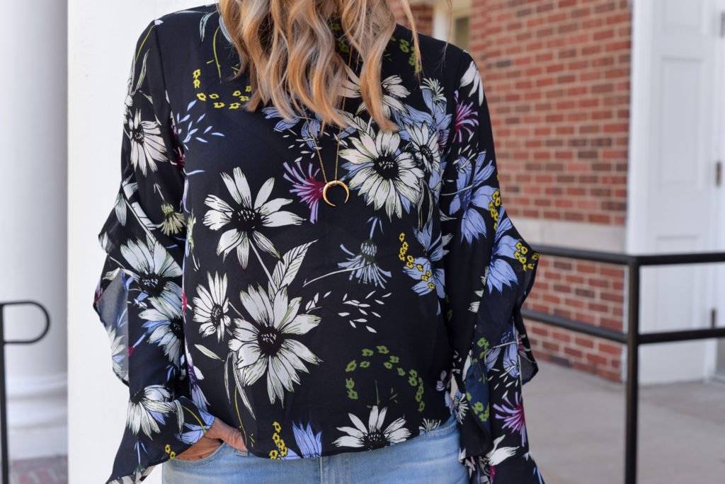 Floral top, denim, sunglasses, pink purse, and heels