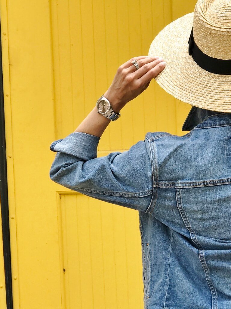 Black maxi dress, denim jacket, straw hat
