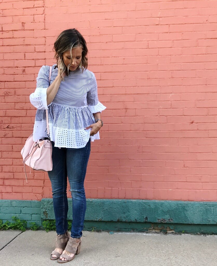 Striped puff sleeve blouse, denim jeans, sandals, pink purse, and beaded earrings
