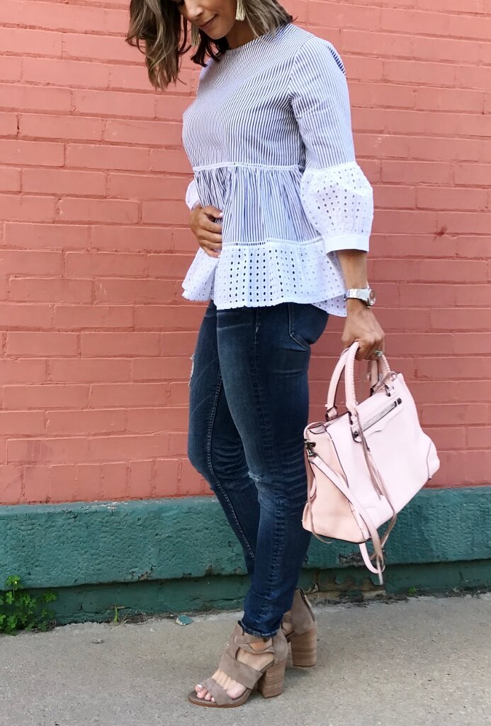 Striped puff sleeve blouse, denim jeans, sandals, pink purse, and beaded earrings