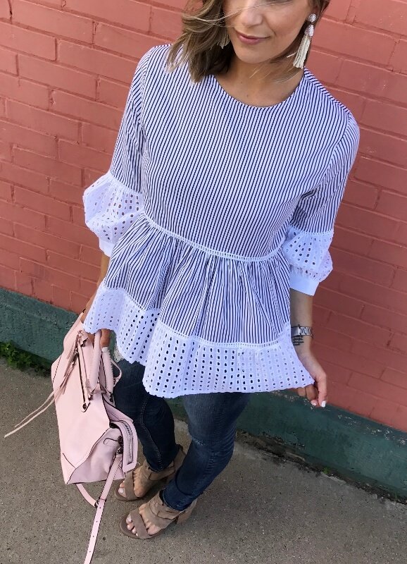 Striped puff sleeve blouse, denim jeans, sandals, pink purse, and beaded earrings