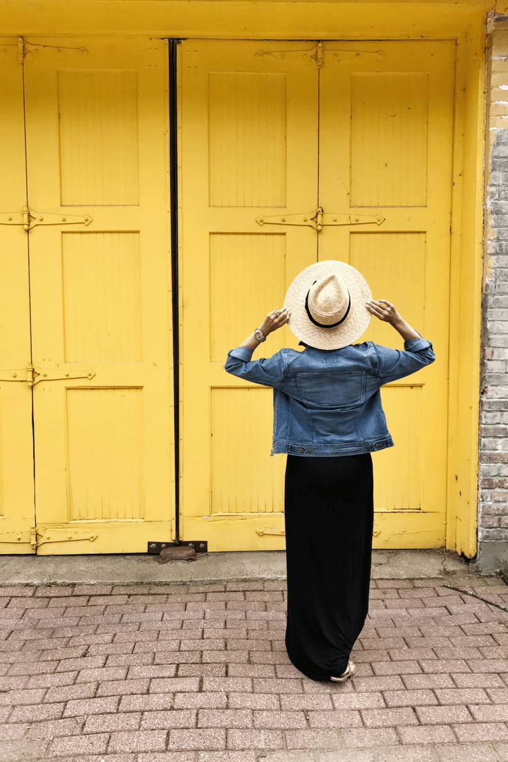 Black maxi dress, denim jacket, straw hat