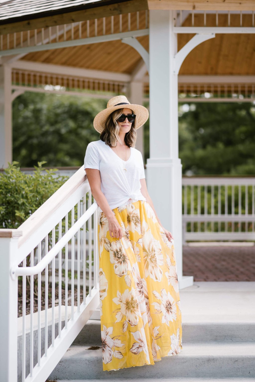 Summer style: floral maxi skirt, white tee, straw hat, sunglasses, sandals