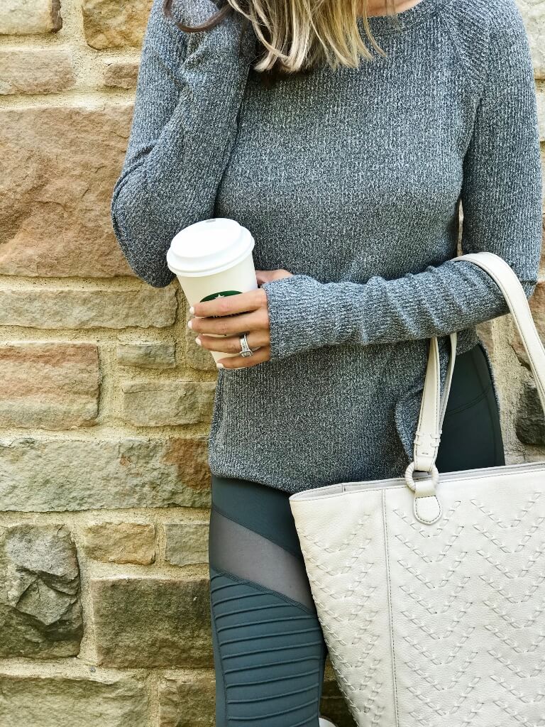 Sweater, moto leggings, tote, sneakers, and sunglasses