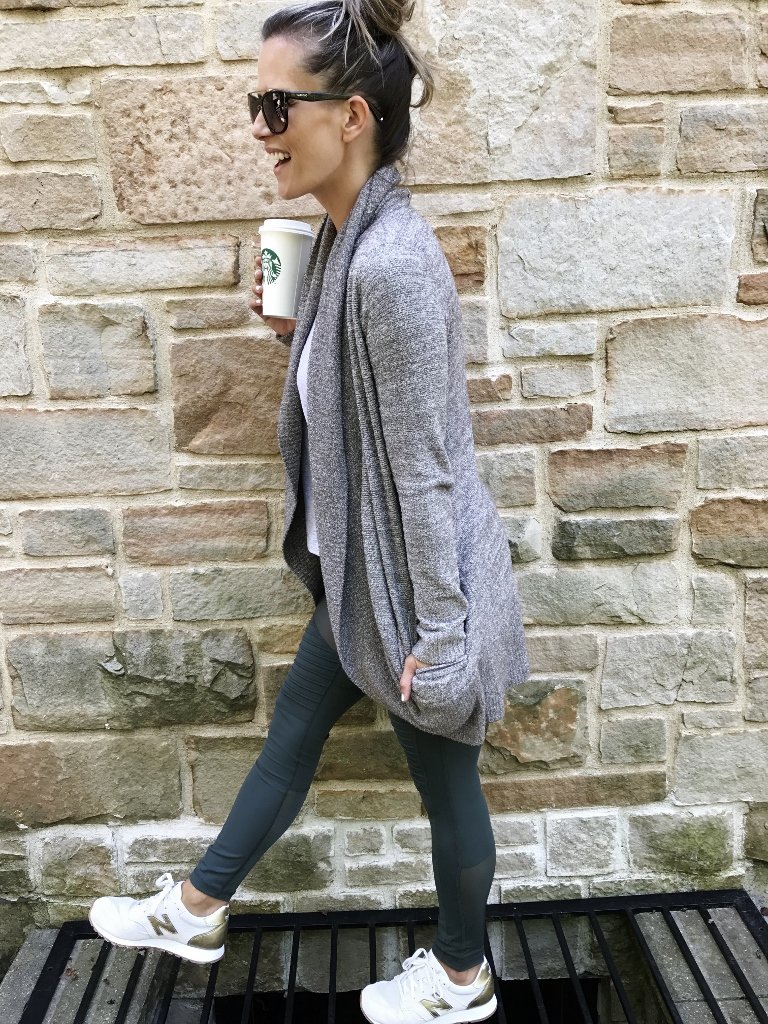 Sweater, moto leggings, tote, sneakers, and sunglasses