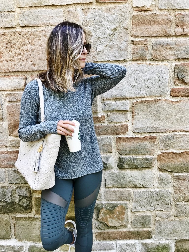 Sweater, moto leggings, tote, sneakers, and sunglasses