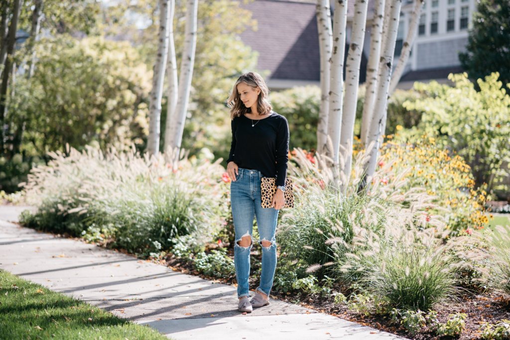 Black long sleeve tee, mom jeans, mules, and clutch