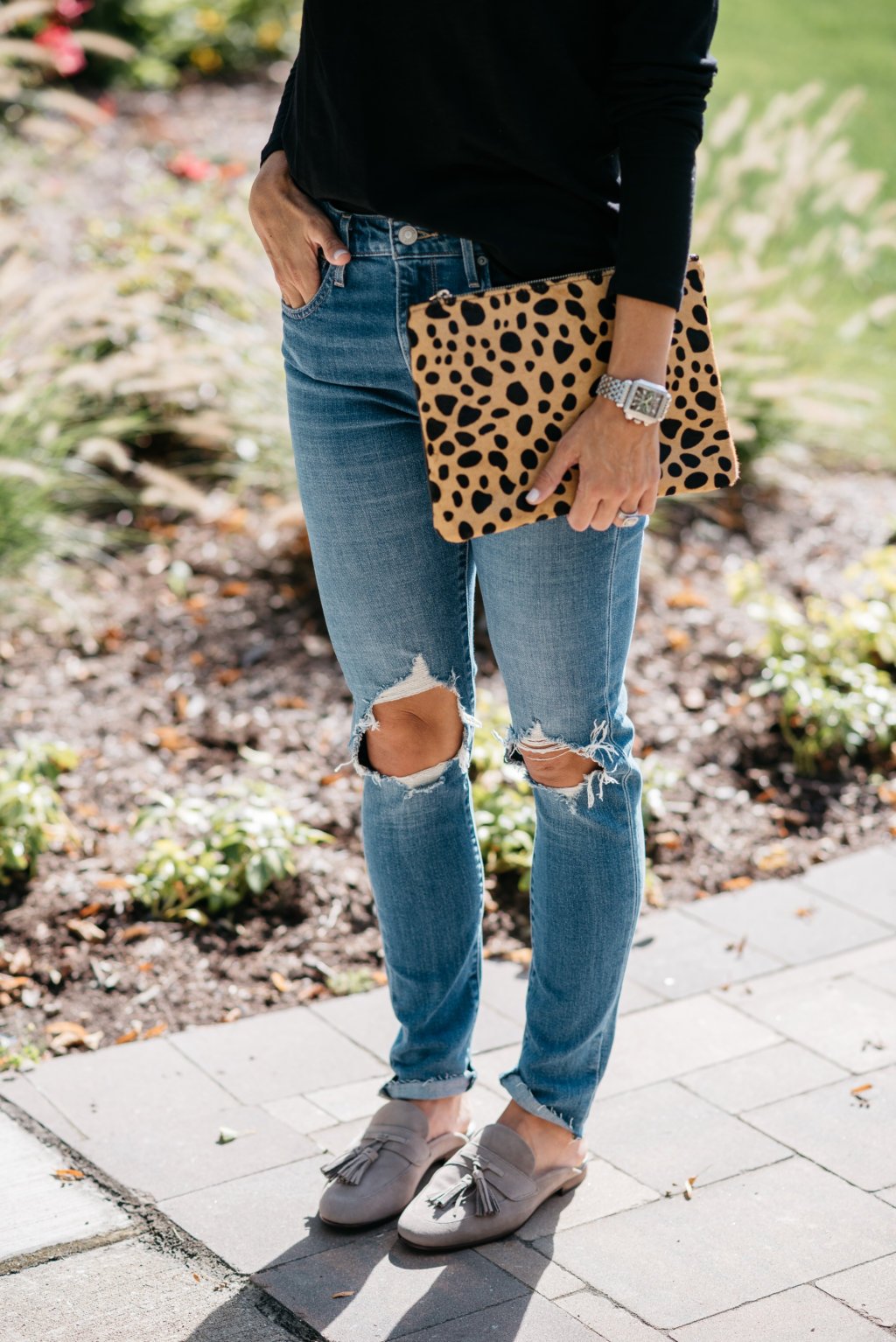 Black long sleeve tee, mom jeans, mules, and clutch