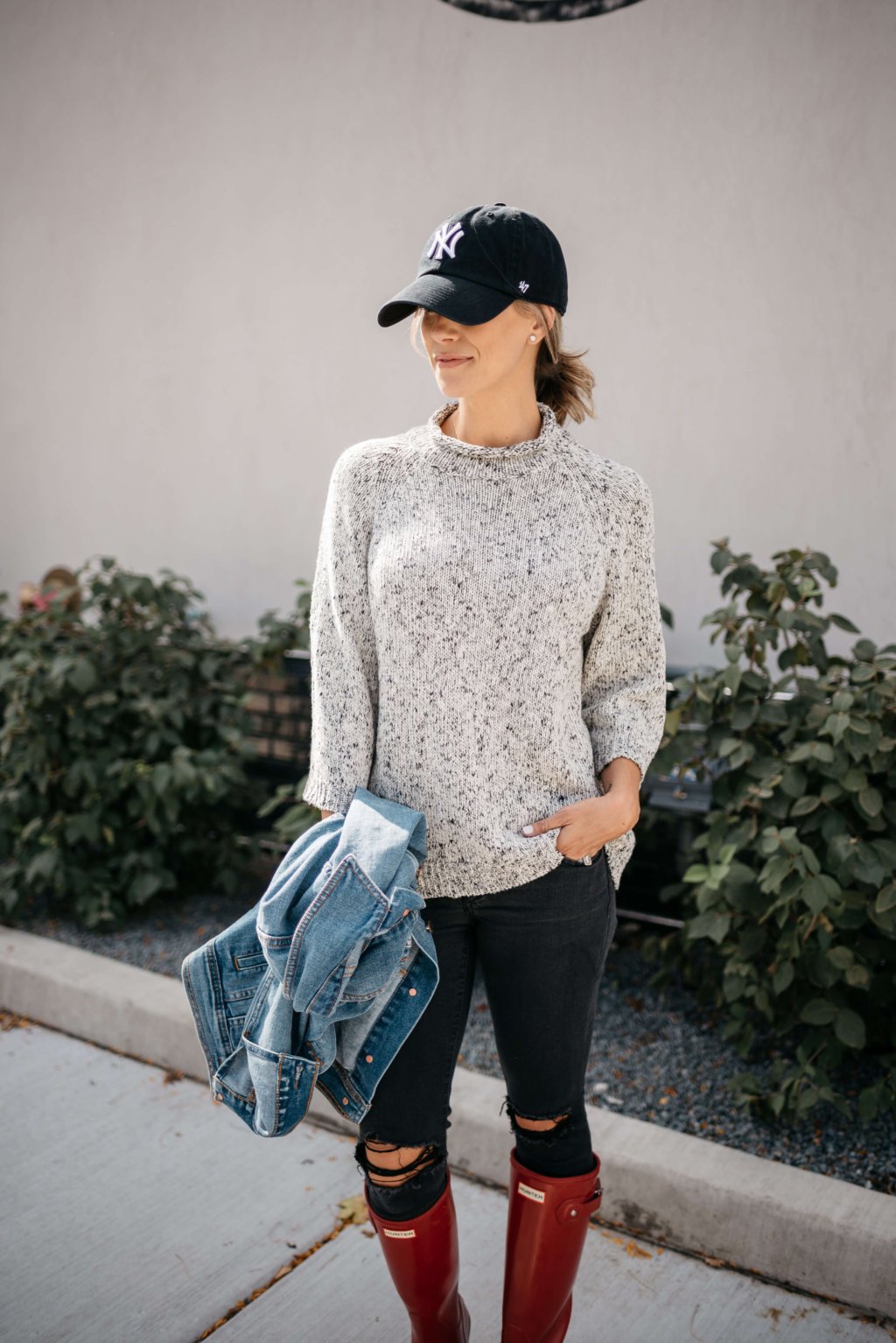 Sweater, black denim, jean jacket, baseball hat, Hunter boots