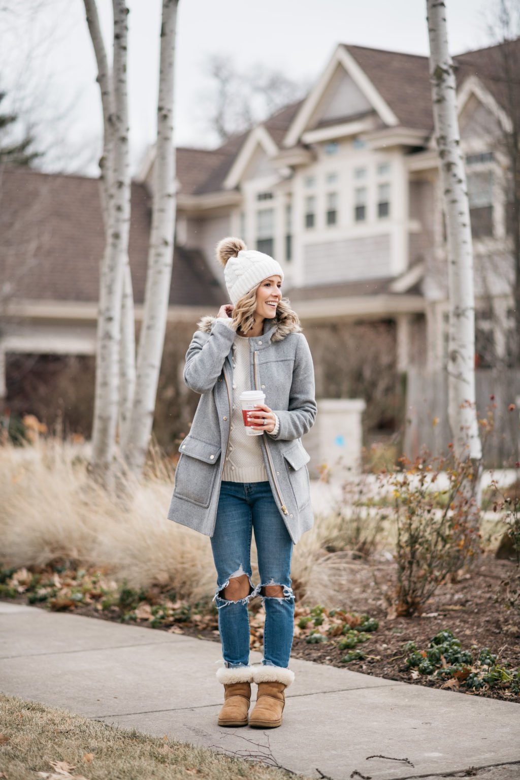 Parka, sweater, pom beanie, denim, and boots