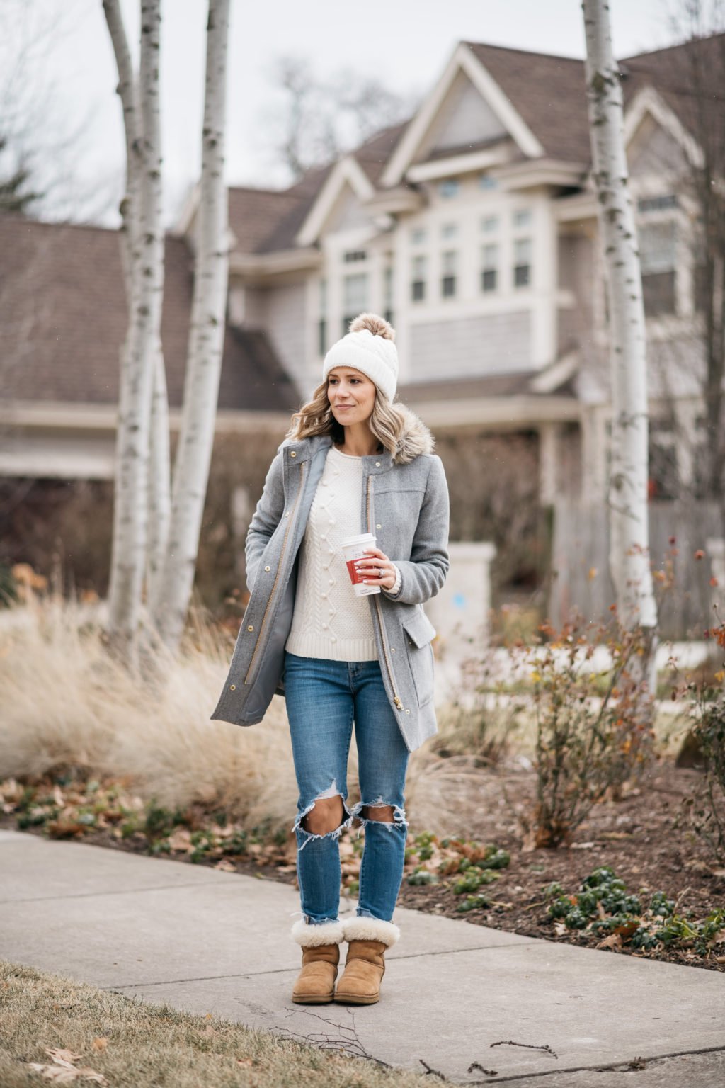 Parka, sweater, pom beanie, denim, and boots