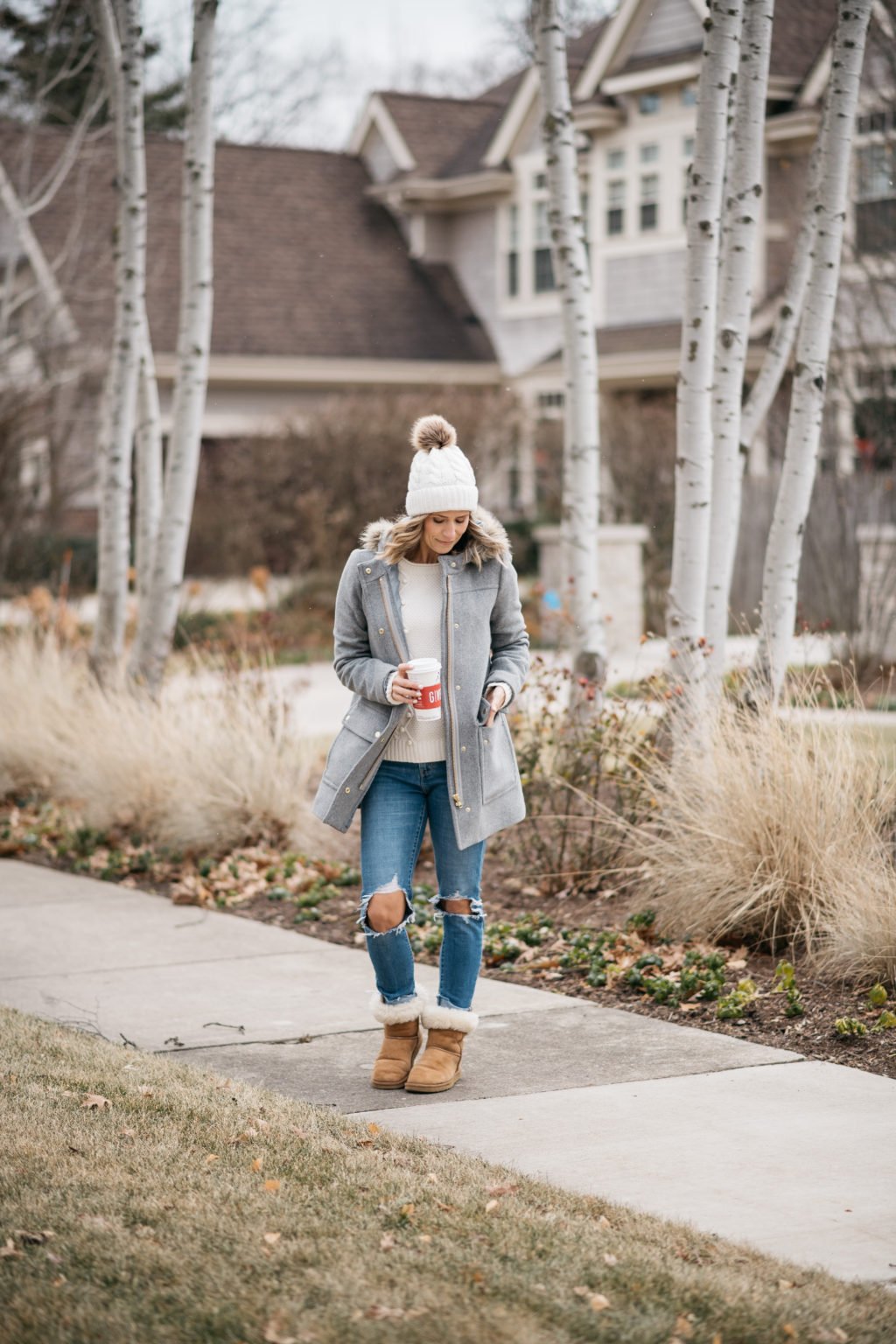 Parka, sweater, pom beanie, denim, and boots