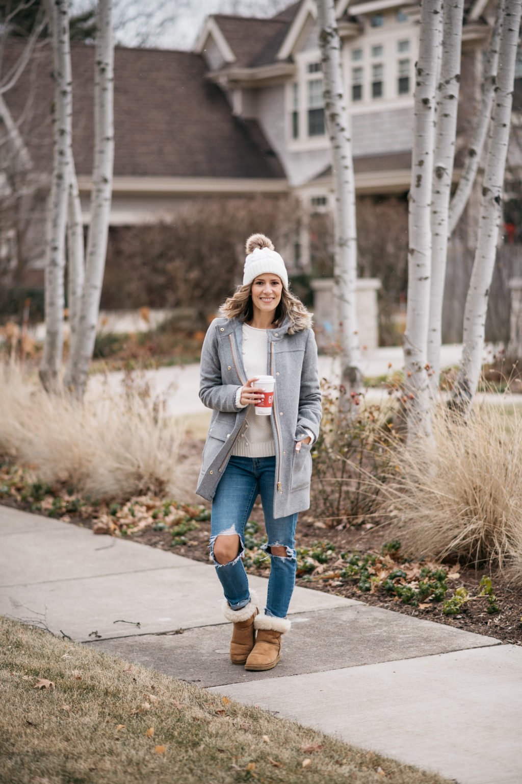 Parka, sweater, pom beanie, denim, and boots