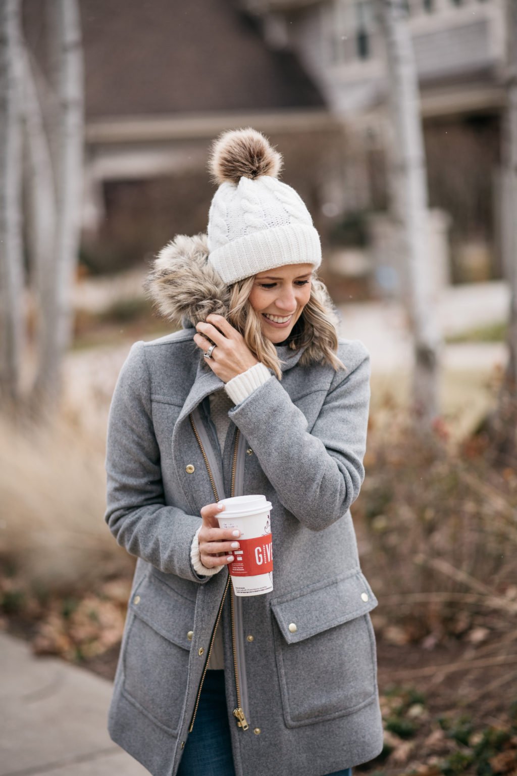 Parka, sweater, pom beanie, denim, and boots