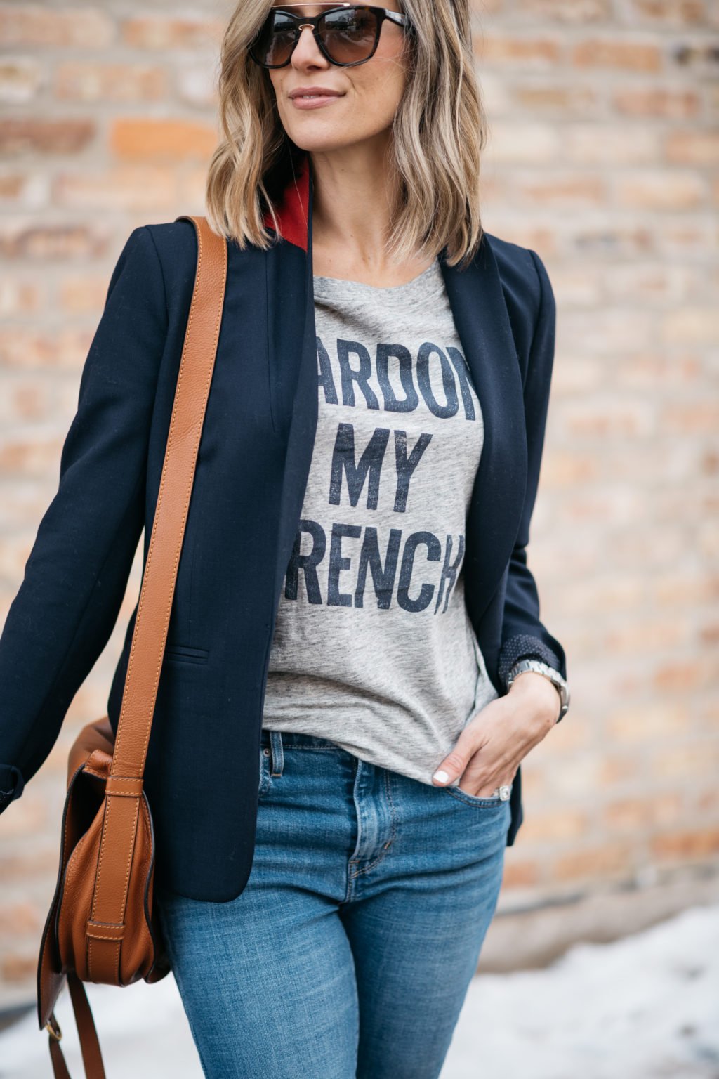 Blazer, graphic tee, sunglasses, denim, crossbody, sneakers