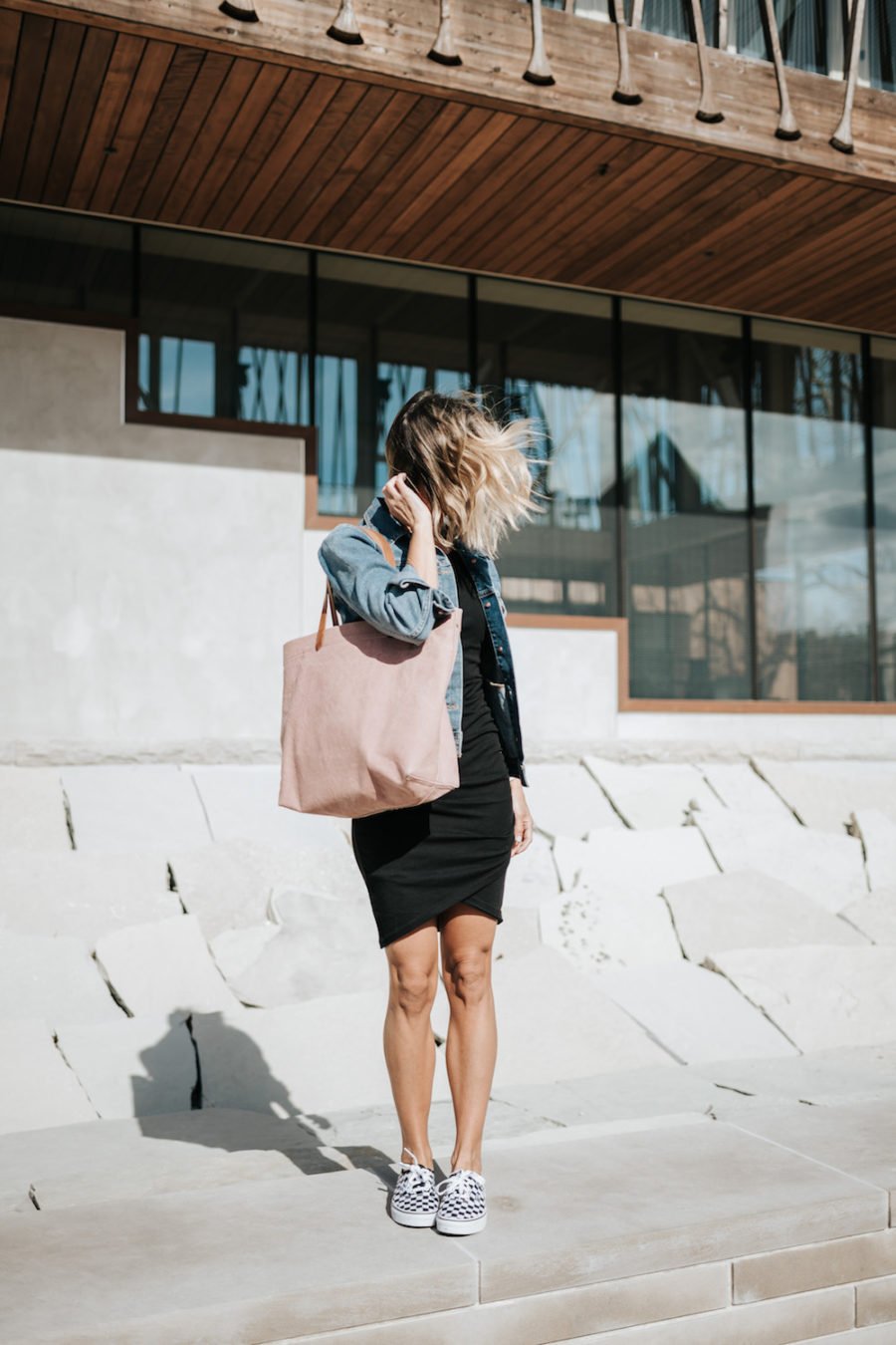 Daytime to date night: tank dress, denim jacket, pink tote, sneakers