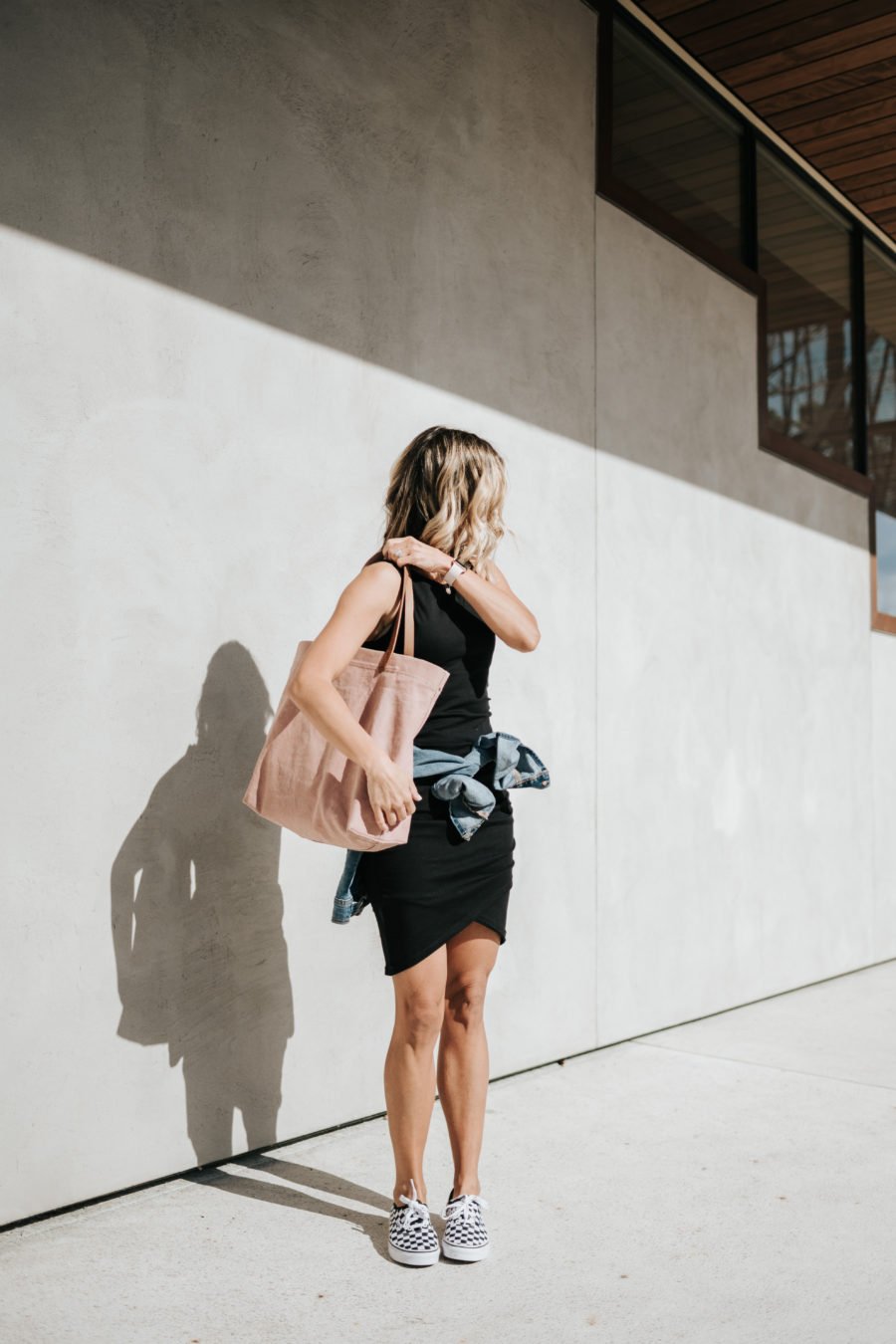 Daytime to date night: tank dress, denim jacket, pink tote, sneakers