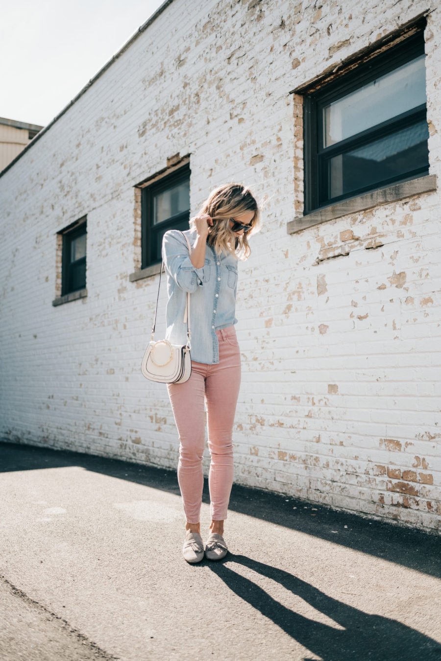 Denim shirt, pink jeans, Chloe dupe bag, sunglasses, and mules