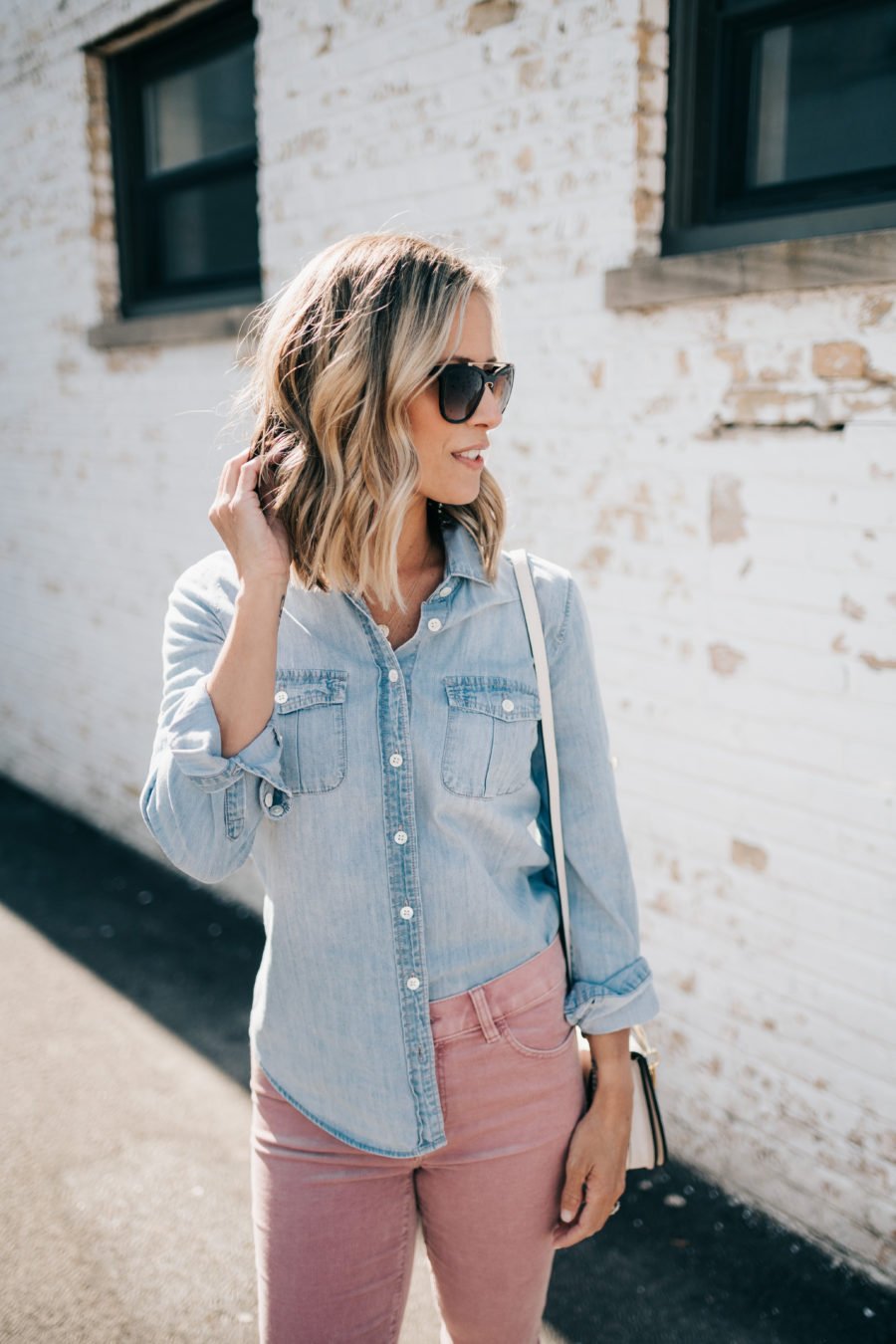 Denim shirt, pink jeans, Chloe dupe bag, sunglasses, and mules