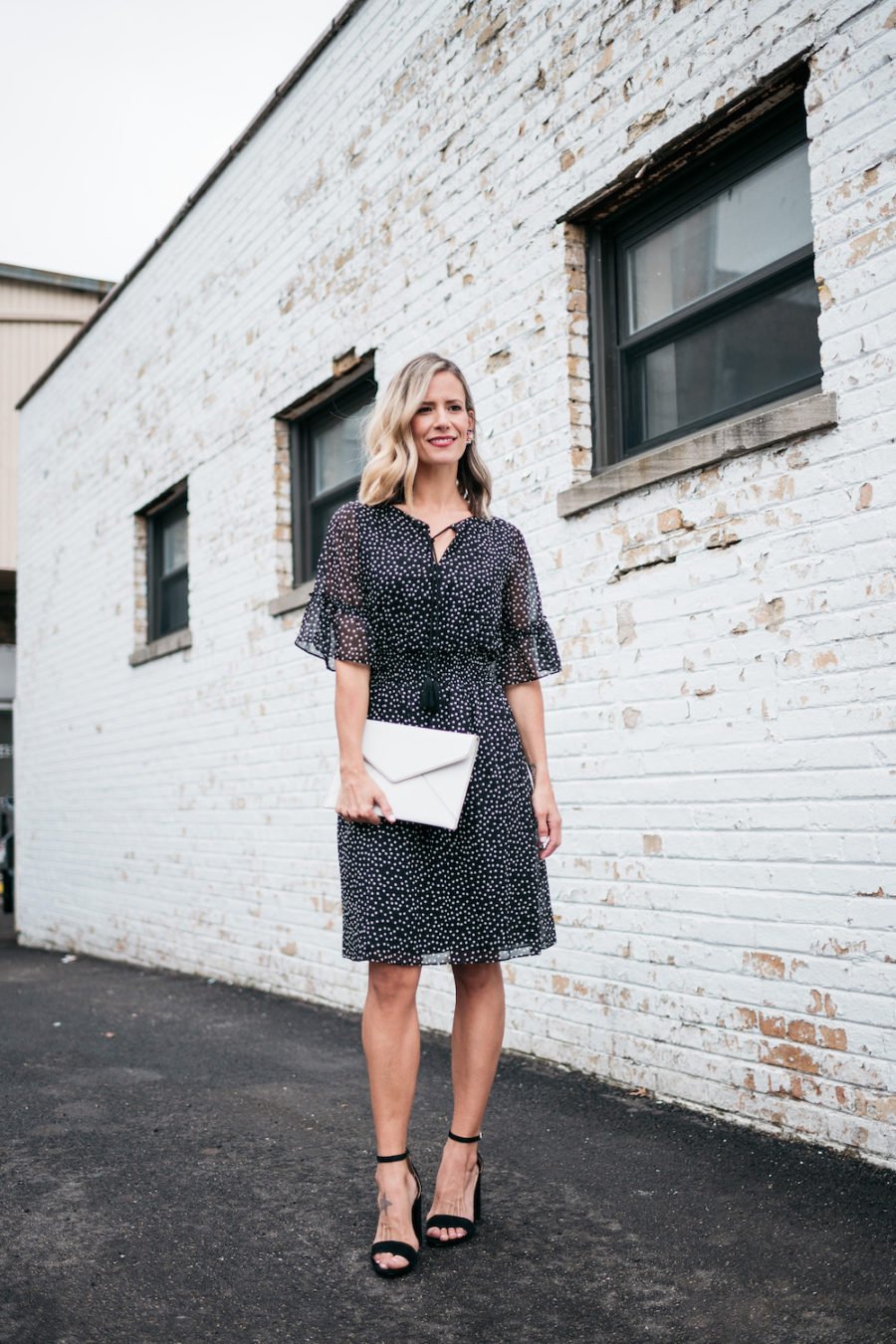 polka dots and ruffle spring dress, white clutch, black heels