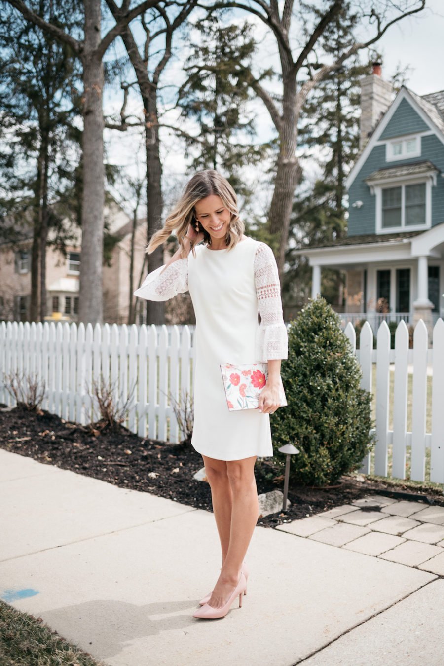 White lace dress, floral clutch, pink pumps