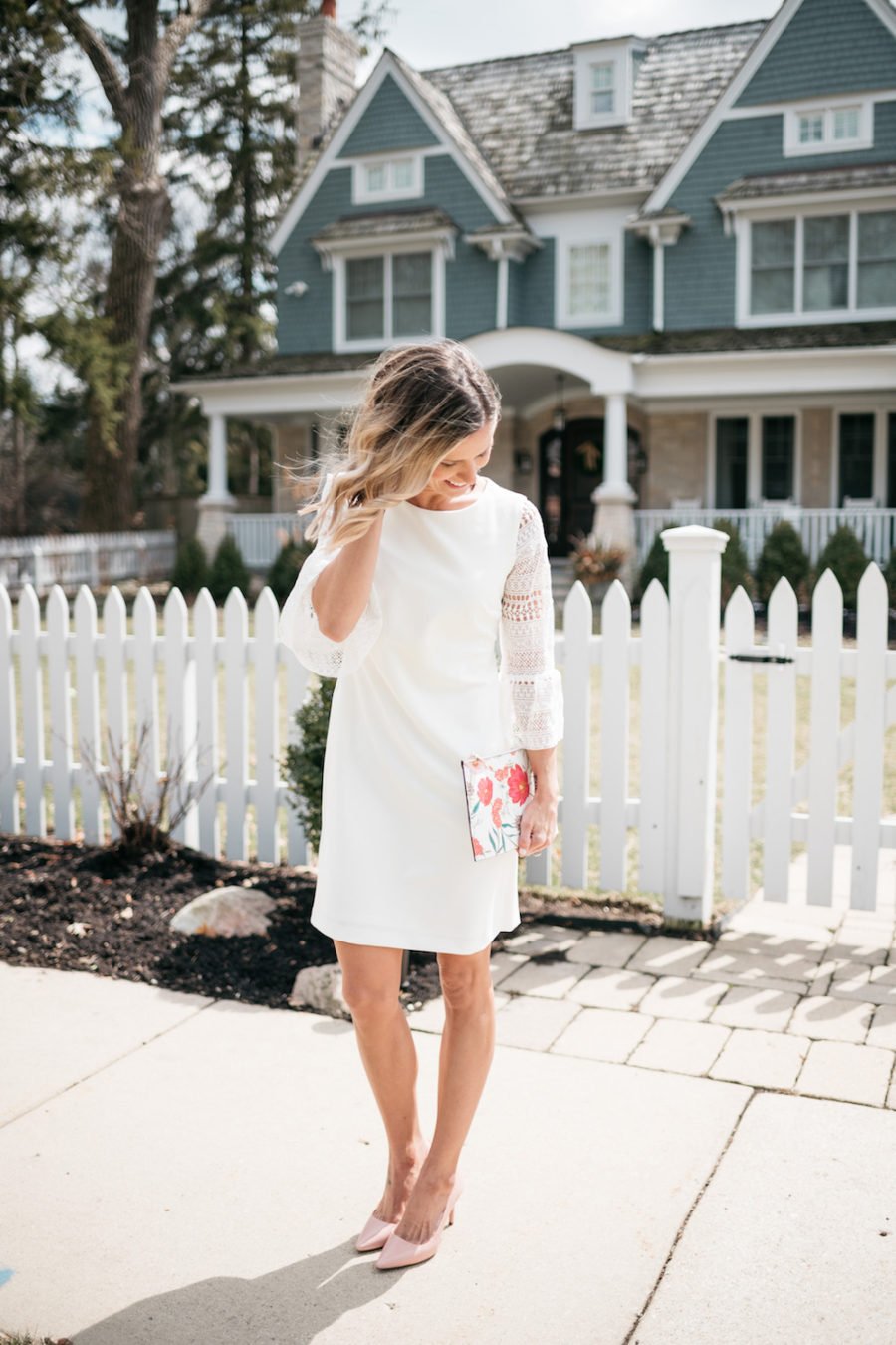 White lace dress, floral clutch, pink pumps
