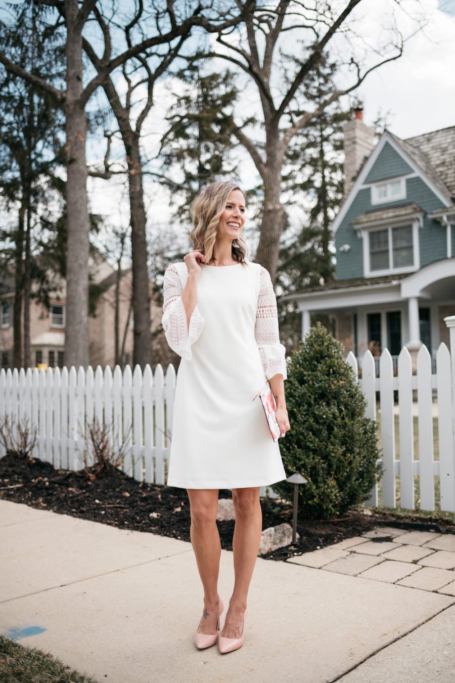 White lace dress, floral clutch, pink pumps