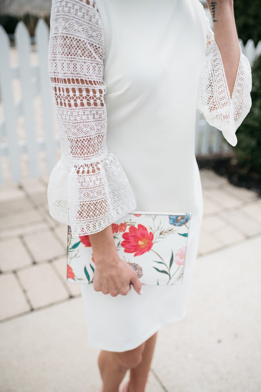 White lace dress, floral clutch, pink pumps