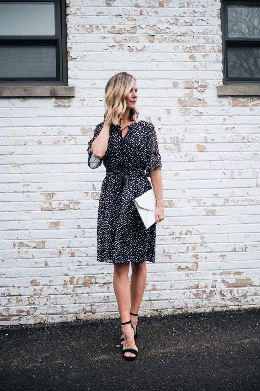 polka dots and ruffle spring dress, white clutch, black heels