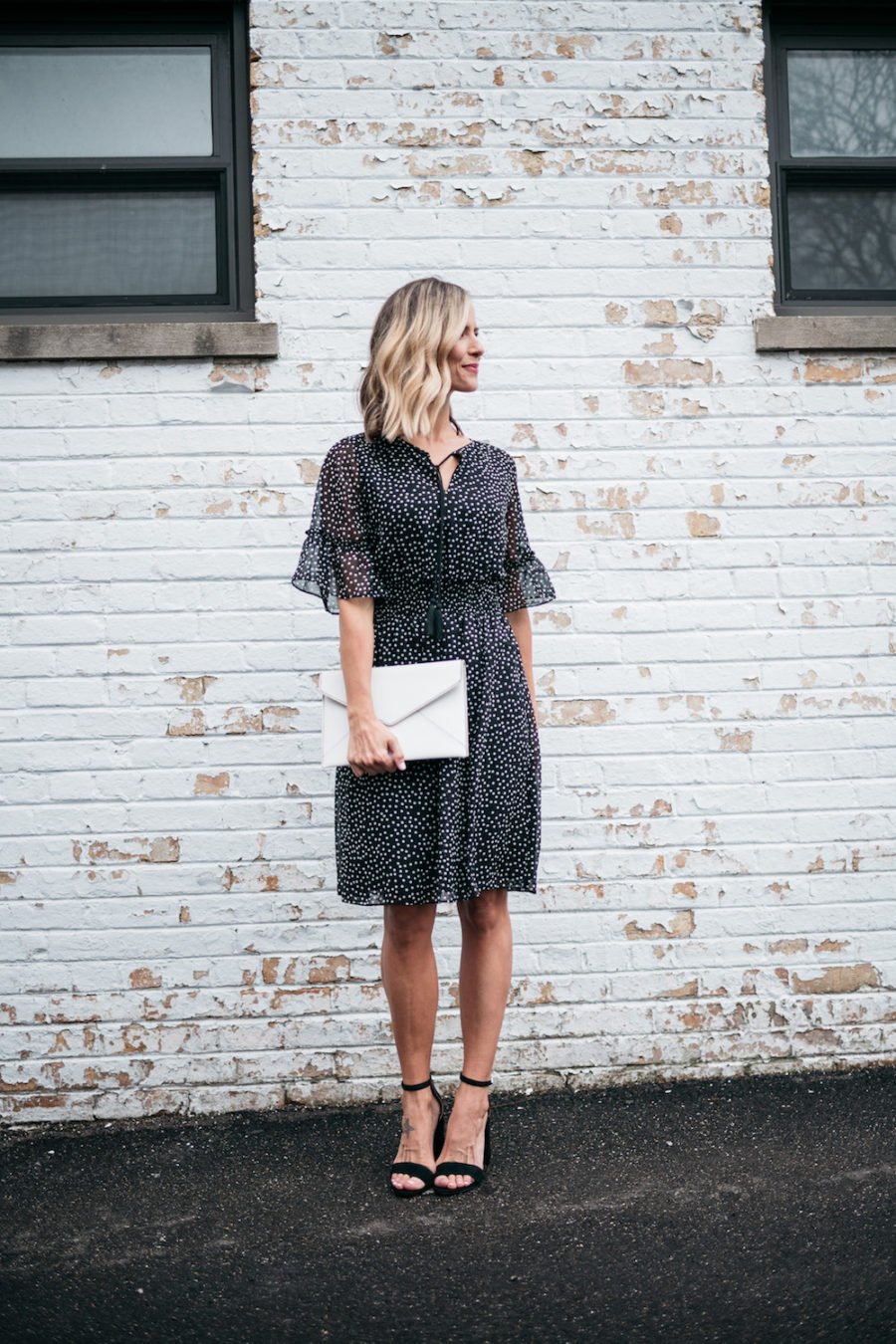 polka dots and ruffle spring dress, white clutch, black heels