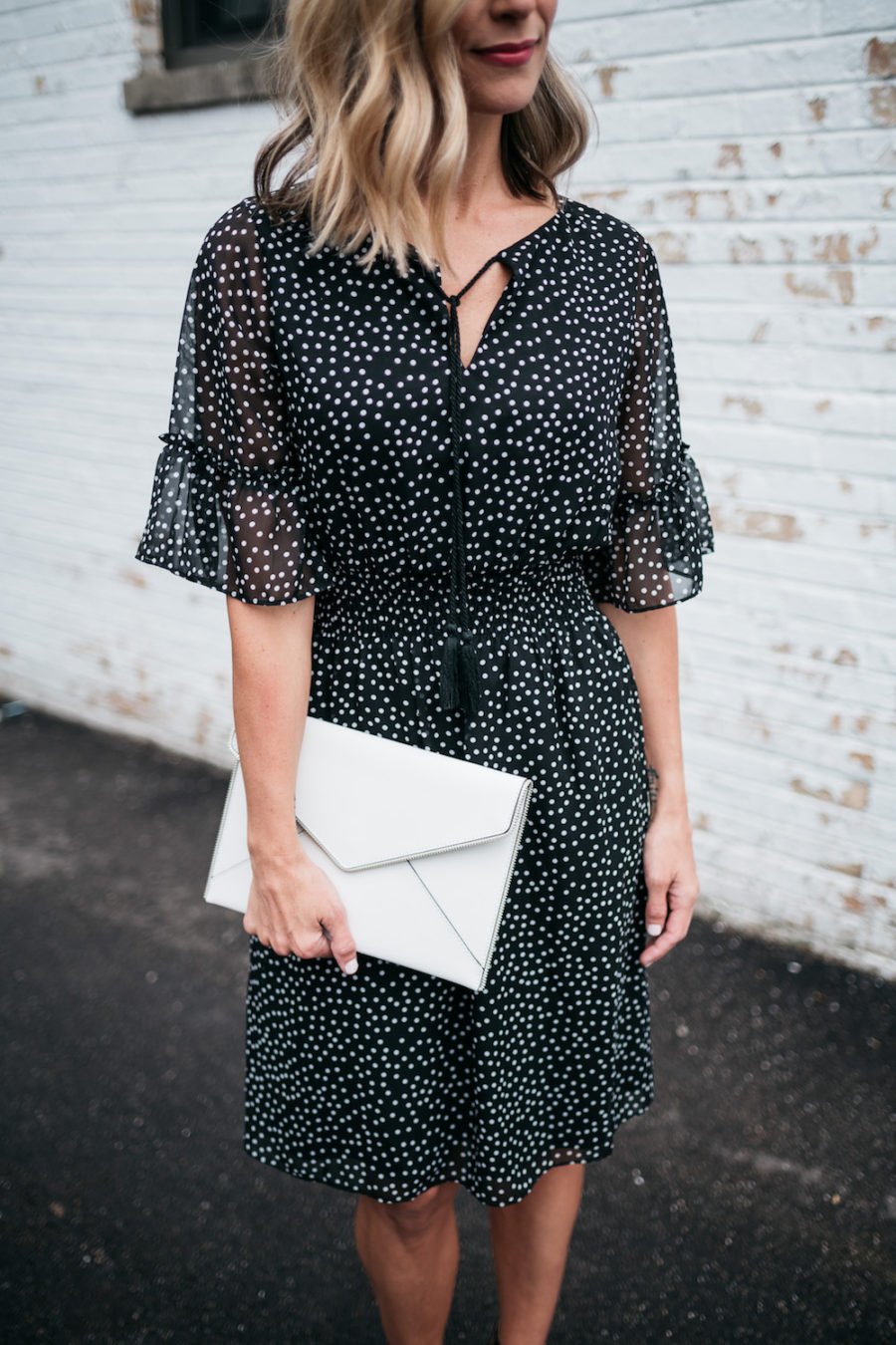 polka dots and ruffle spring dress, white clutch, black heels