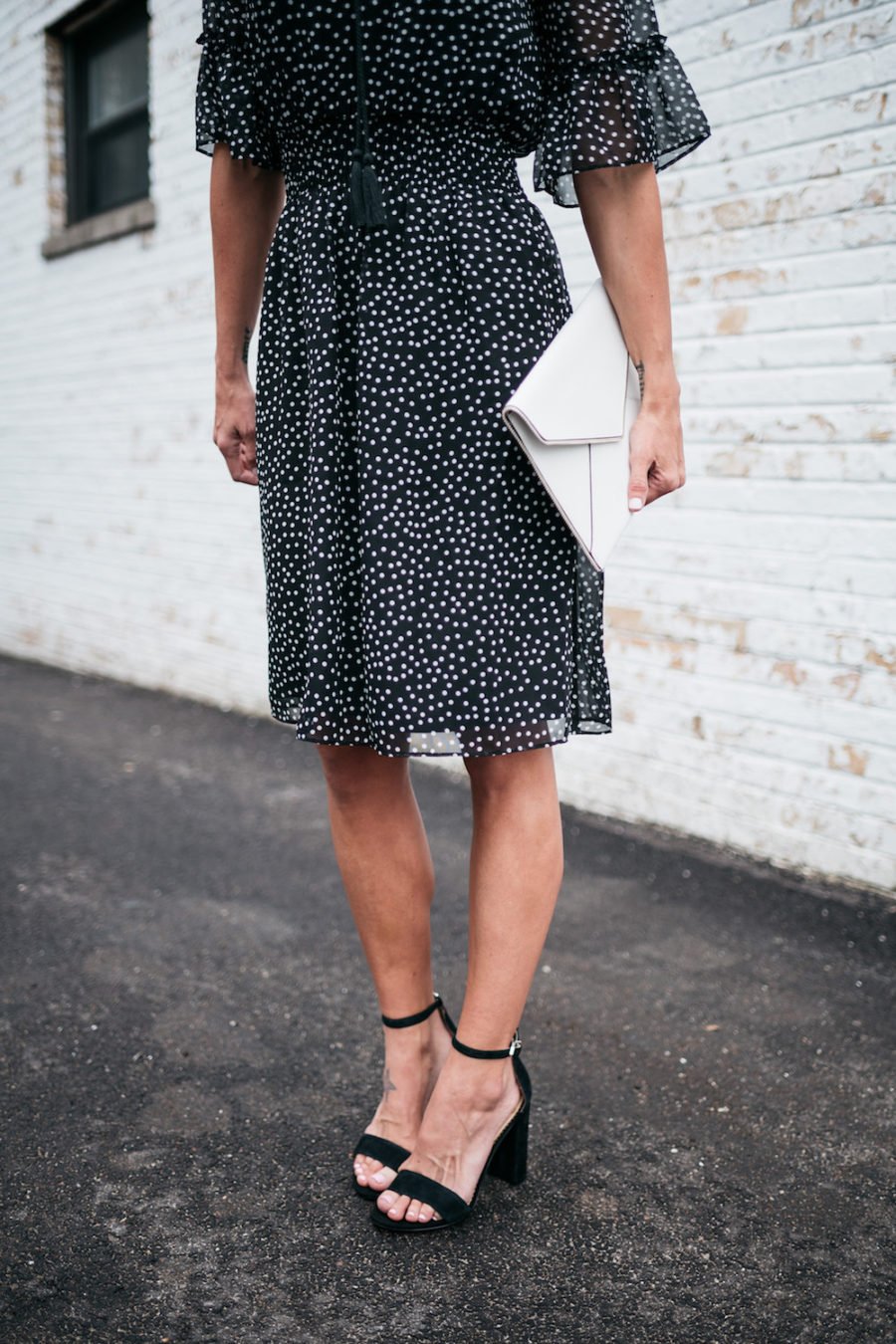 polka dots and ruffle spring dress, white clutch, black heels