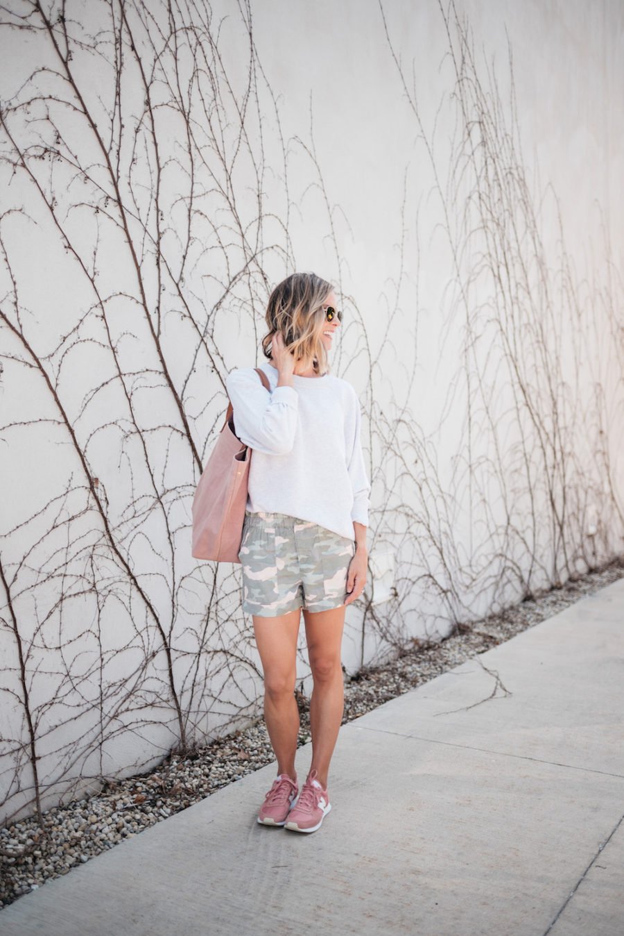 Sweatshirt, camo shorts, tote, sunglasses, sneakers