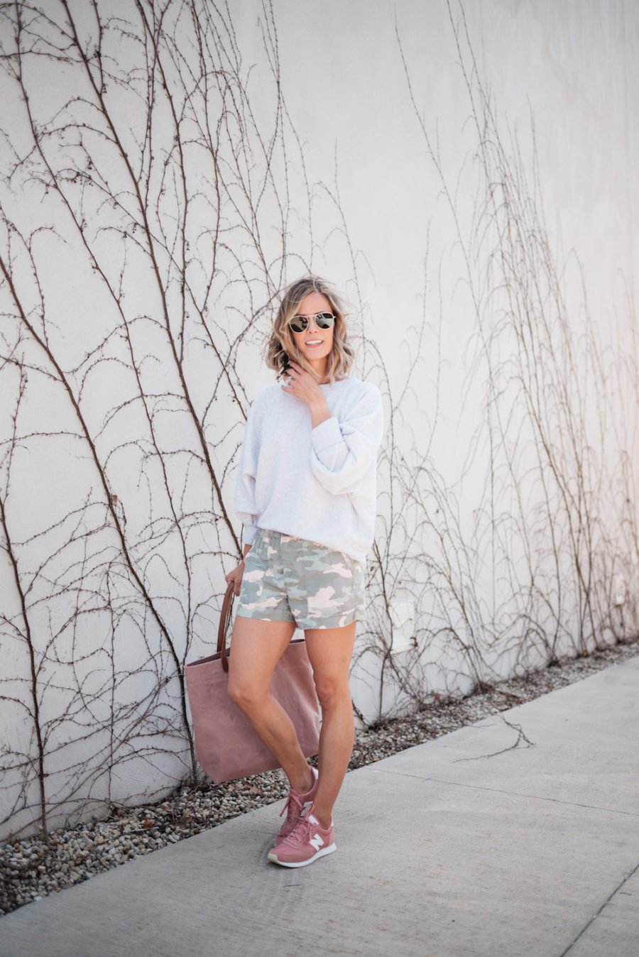 Sweatshirt, camo shorts, tote, sunglasses, sneakers