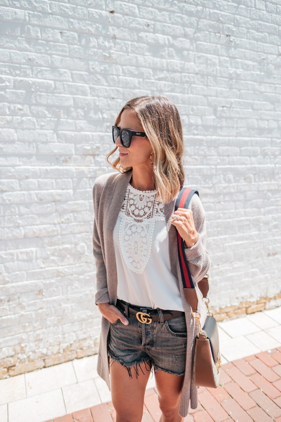 Summer layers: cardigan, white blouse, denim shorts, Gucci belt, crossbody bag, sandals