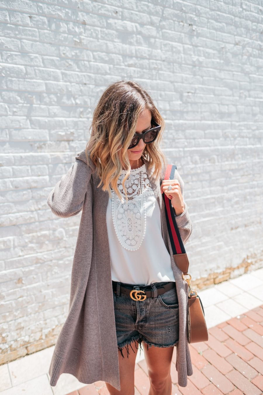 Summer layers: cardigan, white blouse, denim shorts, Gucci belt, crossbody bag, sandals