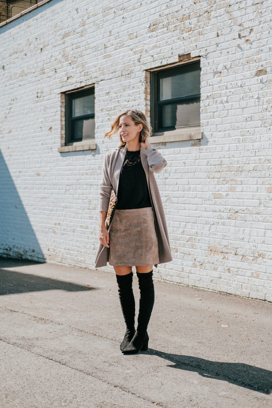 Cardigan, black top, brown suede skirt, leopard bag, over the knee boots