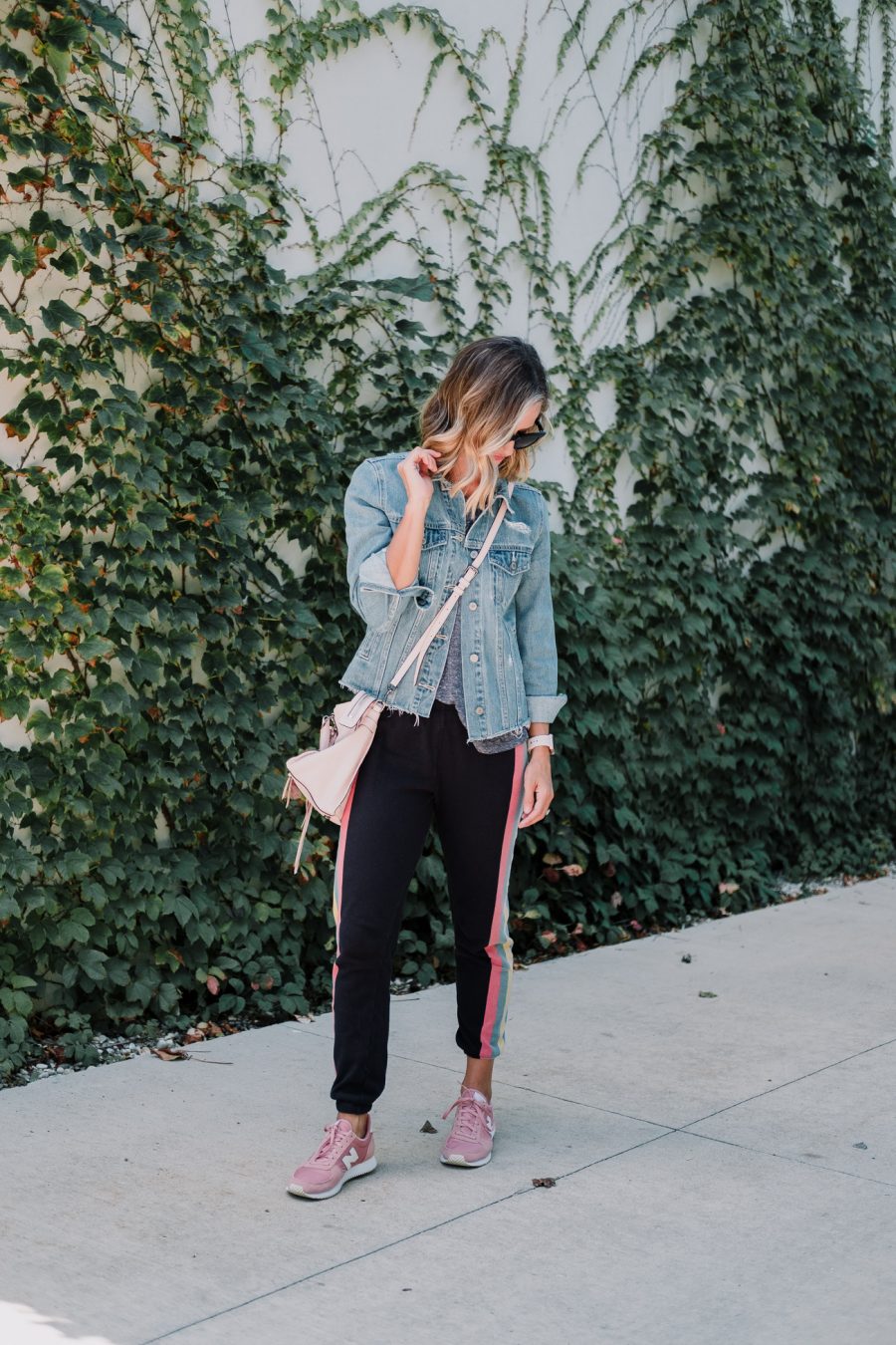 Wildfox sweatpants, tee, denim jacket, New Balance sneakers, cross body bag