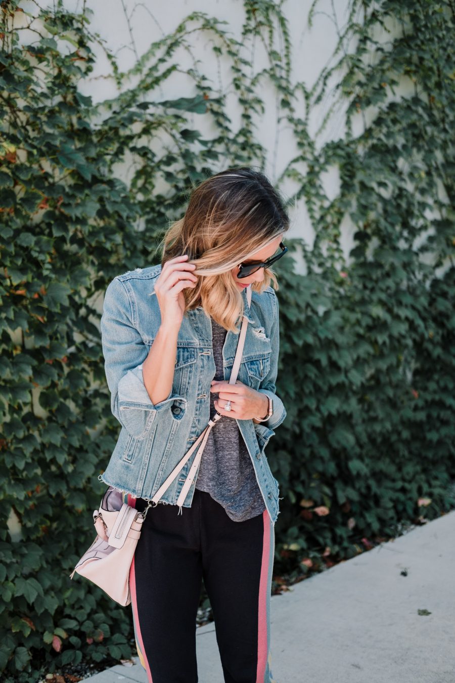 Wildfox sweatpants, tee, denim jacket, New Balance sneakers, cross body bag