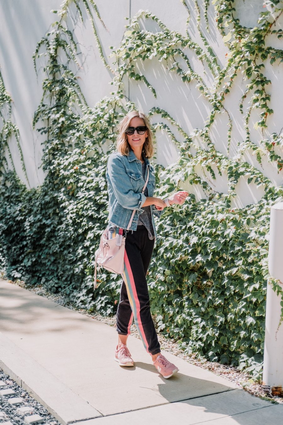 Wildfox sweatpants, tee, denim jacket, New Balance sneakers, cross body bag